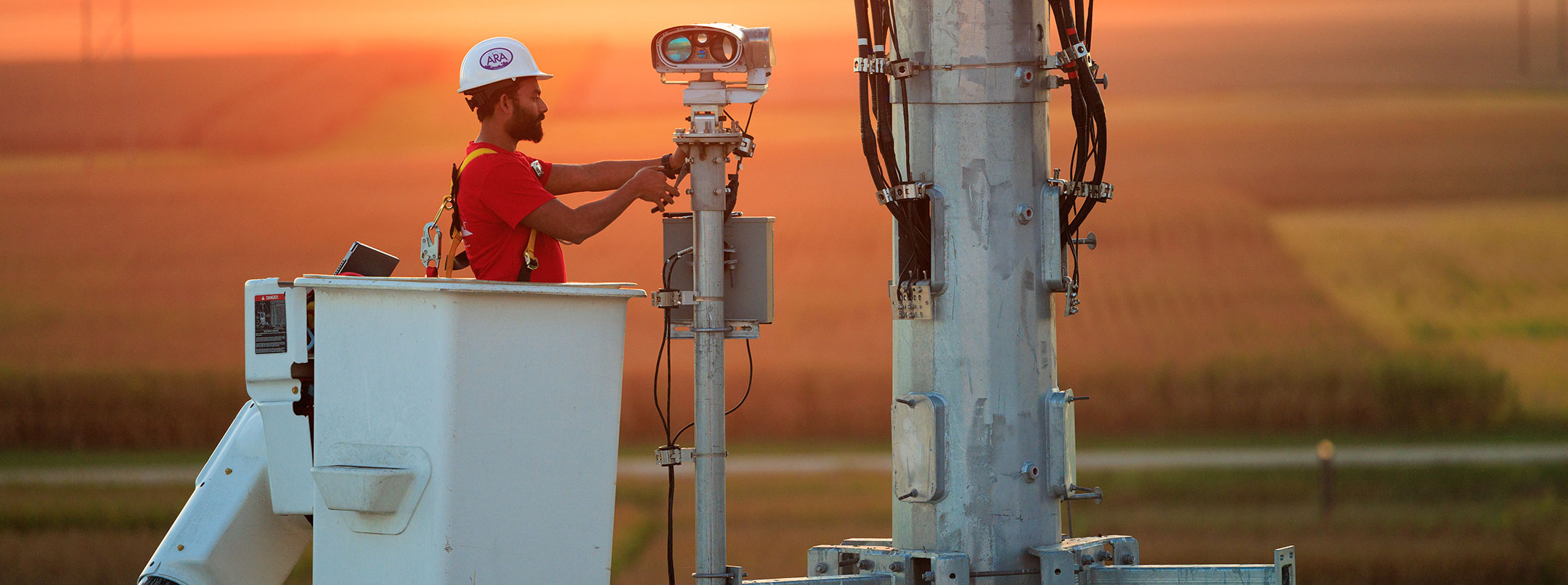 wireless network tower maintenance at sunset