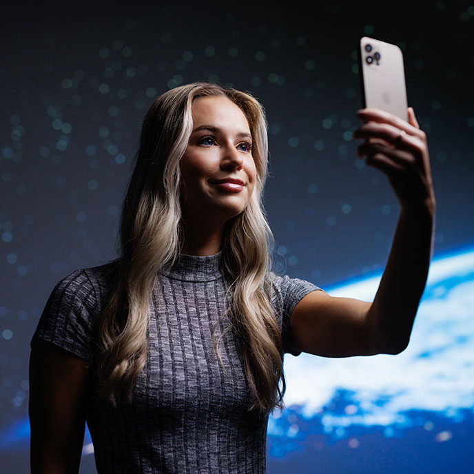 student Emily Anderson holding mobile phone